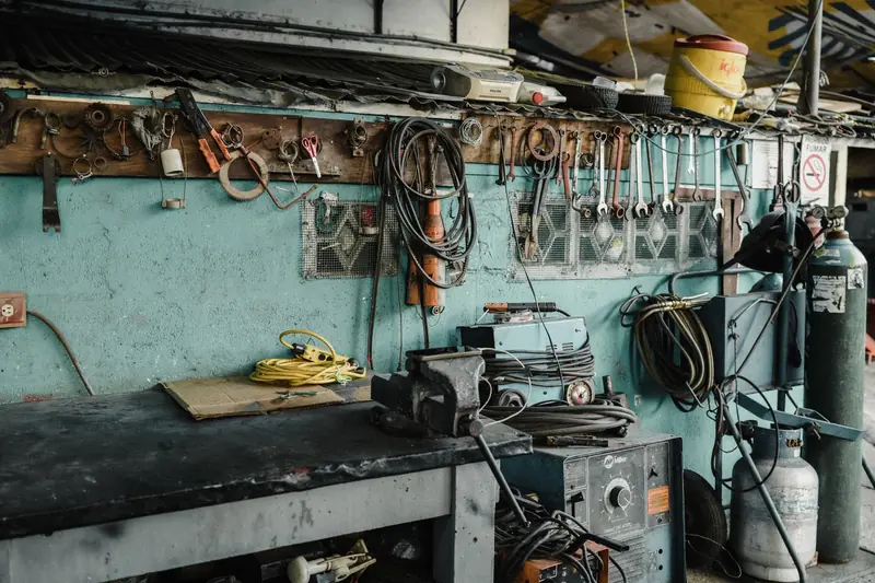 A cluttered workshop space with tools, machinery, and a vise, creating an industrial vibe